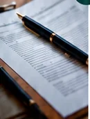 Fountain pen resting on purchase paperwork